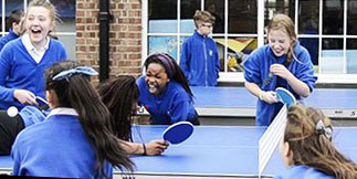 School children playing table tennis on an outdoor table provided by Table Tennis Tables