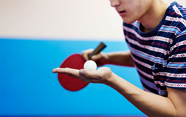 Image of happy children with ping pong bats and balls