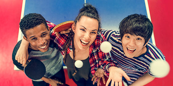 Young table tennis players smile to the camera