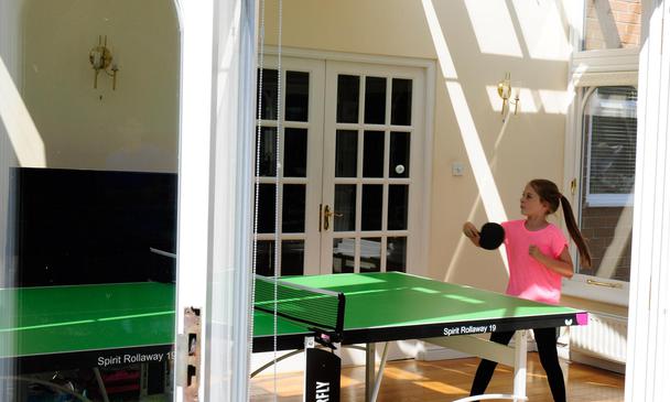 Butterfly Spirit 19 Rollaway Indoor Table Tennis Table With Kid Playing
